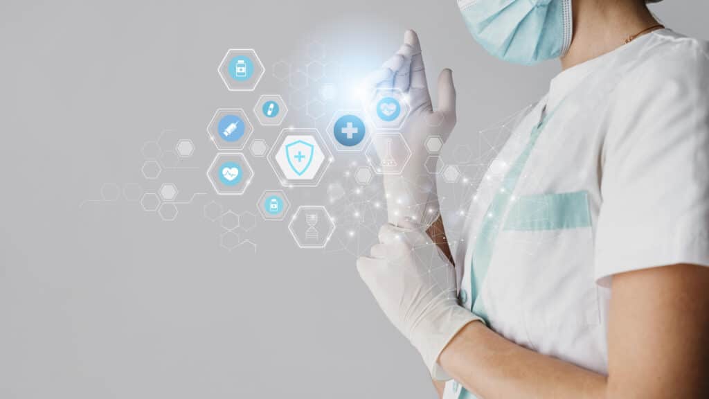 Healthcare professional in scrubs and mask interacting with futuristic digital interface displaying medical icons.